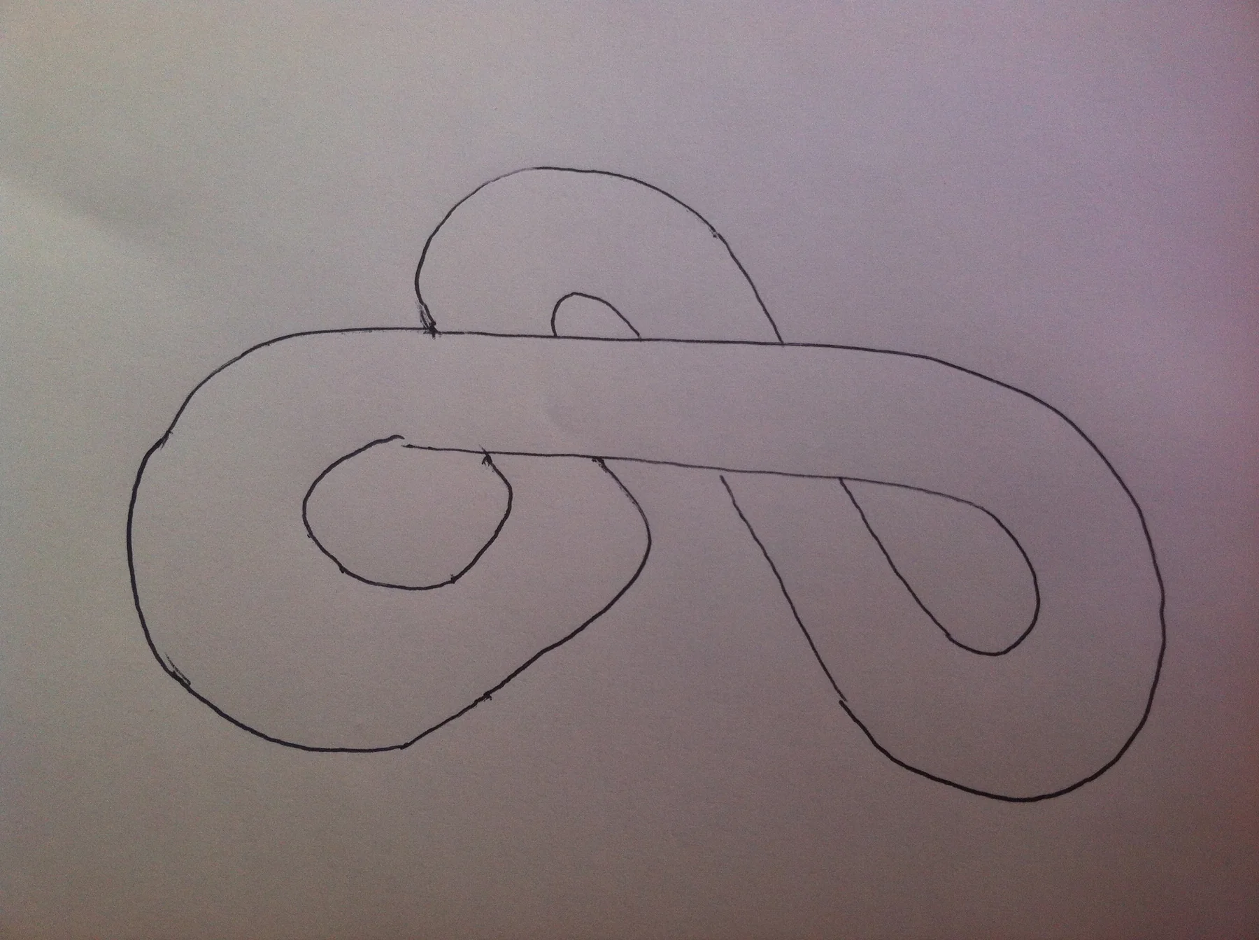 The first Hamster Racing track, drawn by hand in pen on paper: a looping knot that crosses itself