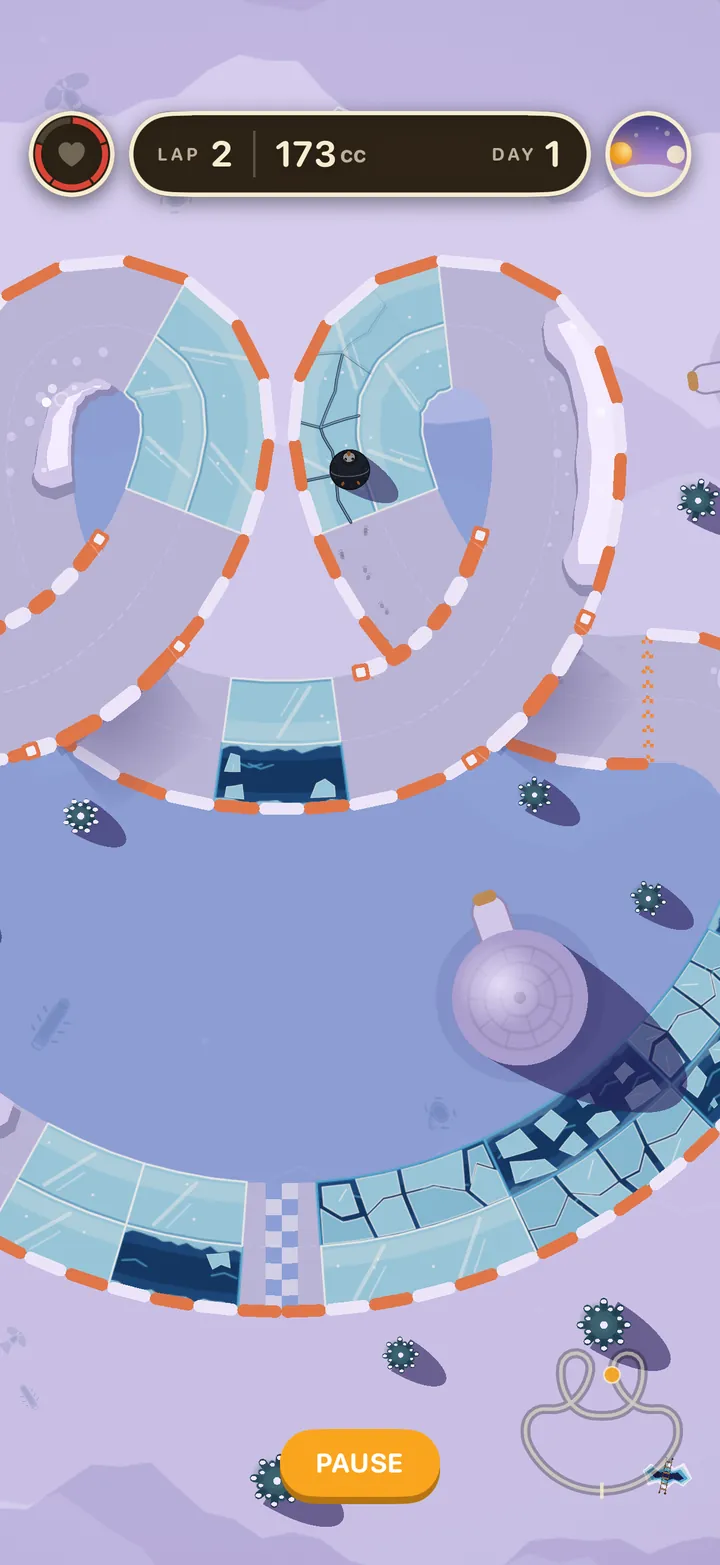 Gift Bag at dusk: the penguin crosses a cracked piece of ice in one of the track's two upper loops, above a frozen lake with an igloo